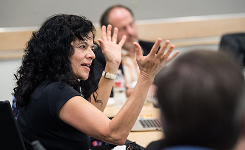 59440-float Person talking with hands at meeting table.