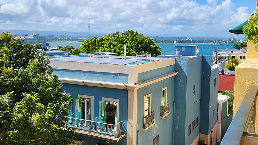 202404-esi-newsletter-fullwidth Aerial view of Puerto Rico ocean coastline with the rooftops of colorful buildings