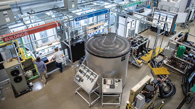 NREL Image Gallery #62082 Photo of two researchers working in the Optimization and Control Laboratory in the ESIF, which has been designed with state-of-the-art commercial buildings research infrastructure.