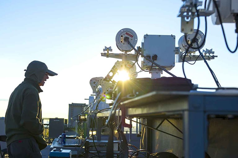 facilities-solar-radiation-lab-22509-thumb Person stands next to solar radiation measurement tool outside