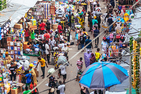 nzw-priority-focus-areas Photo of a busy street in Lagos, Nigeria, with lots of markets and people walking.