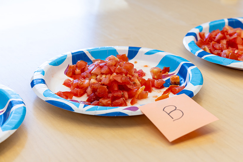 20250603-solar-panels-give-edge-to-tomatoes-grown-underneath-94817 Chopped-up tomatoes sit on plates as part of a taste test.