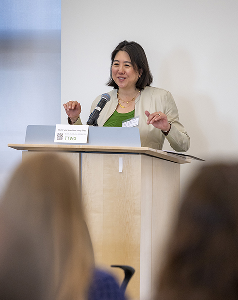A woman speaks at a podium.