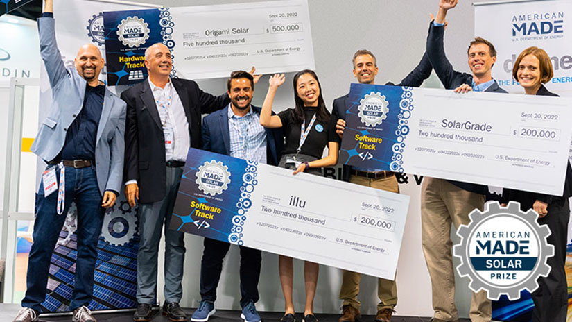 A group of people smile and celebrate, holding up four giant checks.