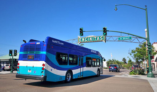 A bus drives under a sign that reads Encinitas.