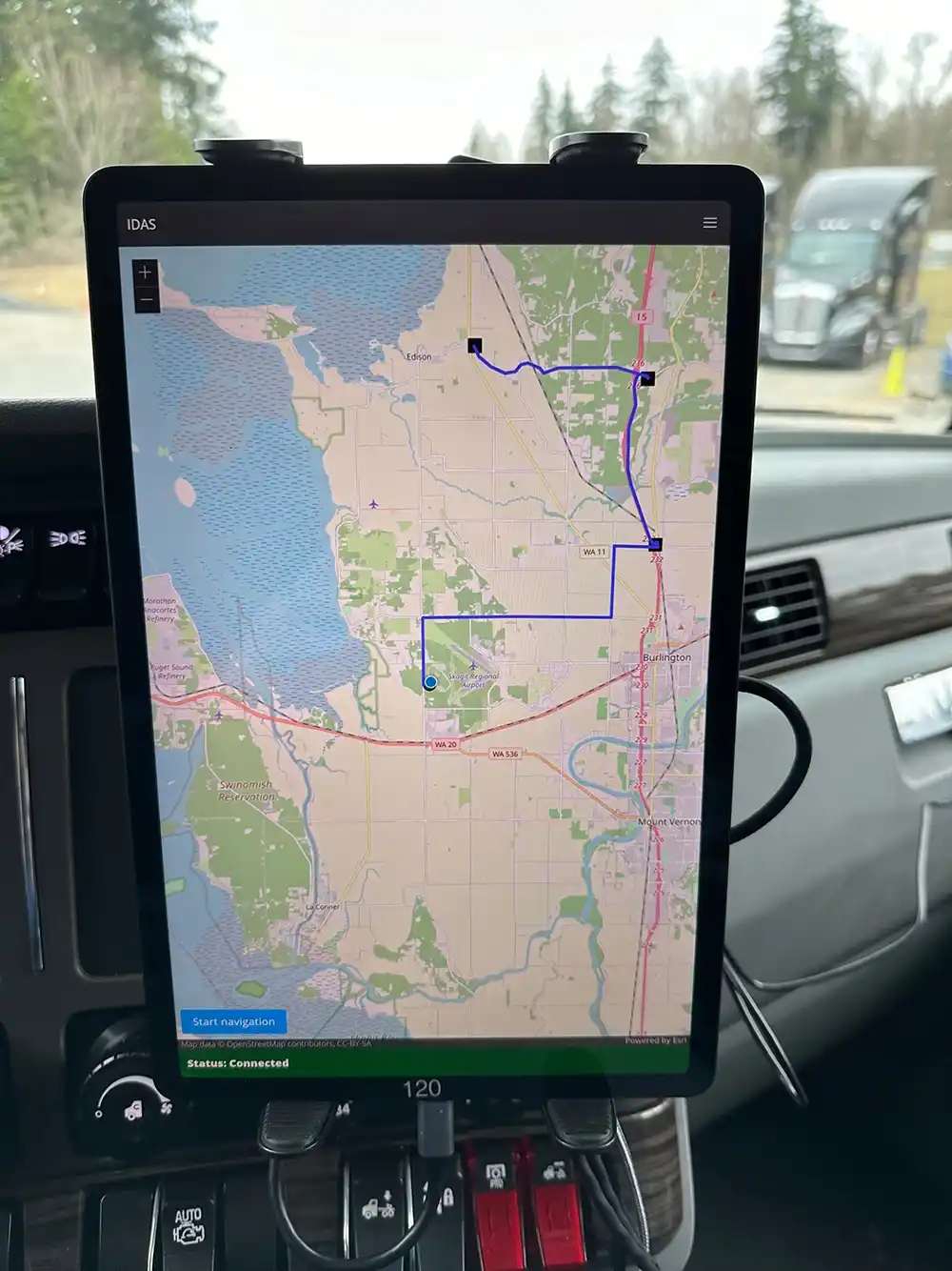20250915-nrel-expertise-contributes-customizable-ready-deploy-tool-package-improve-fleet-efficiency-tablet A close-up of a touchscreen tablet mounted on a vehicle’s dashboard. The tablet shows a route on a map.