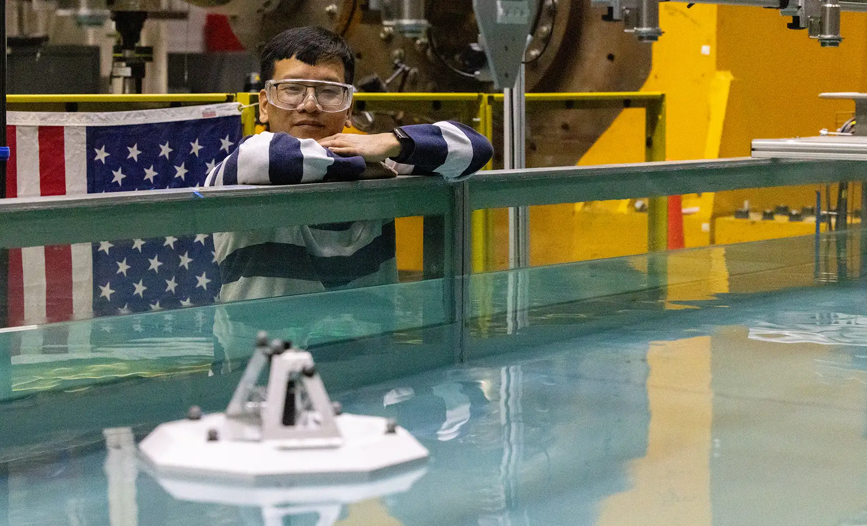 A person standing near a tank of water.