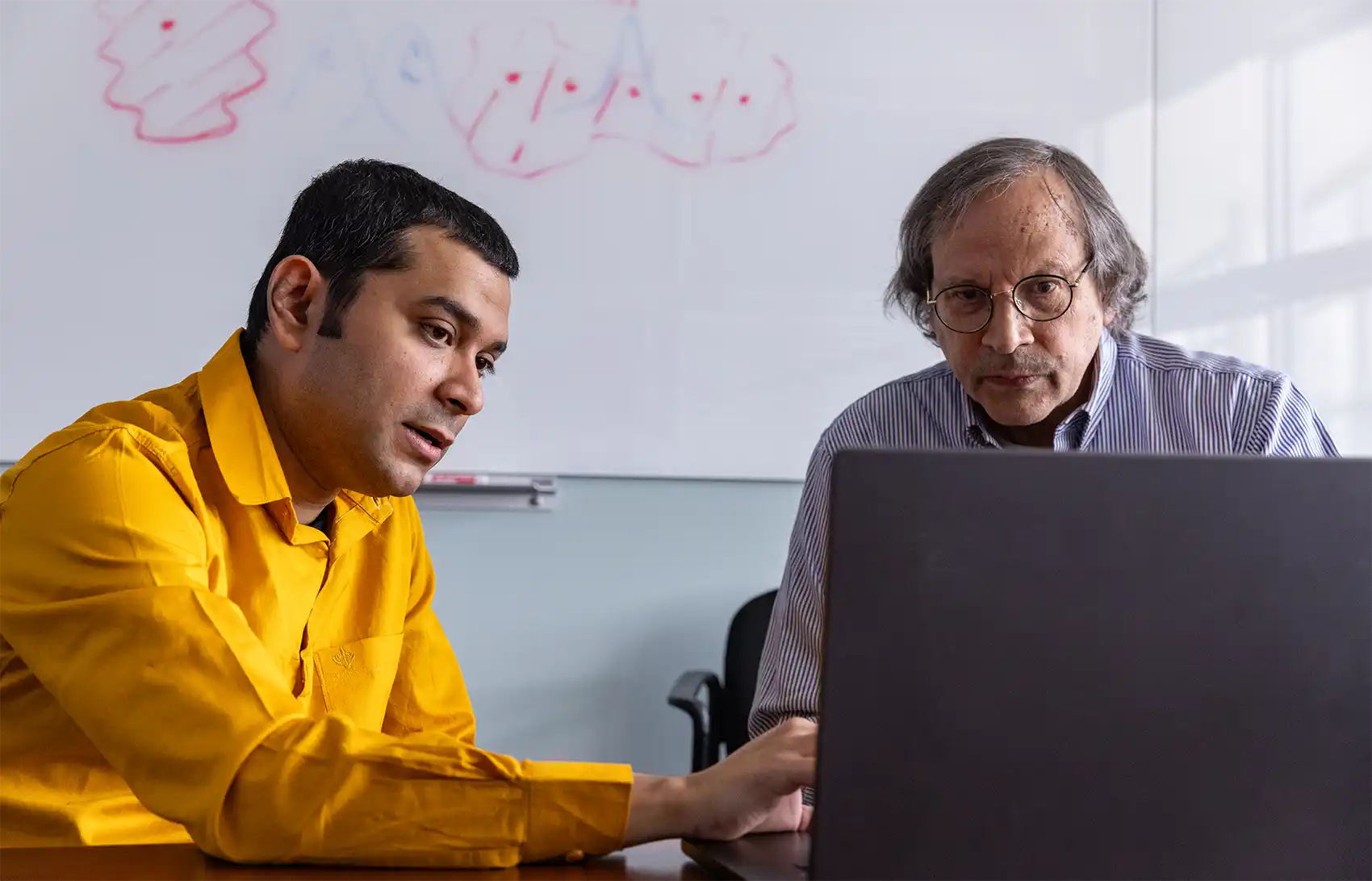 20251201-scientists-describe-exciton-formation-thin-magnetic-crystals-with-potential-for-quantum-computing-other-advanced-technologies-99403 NREL researchers Swagata Acharya and Mark van Schilfgaarde discuss their research on exciton formation.
