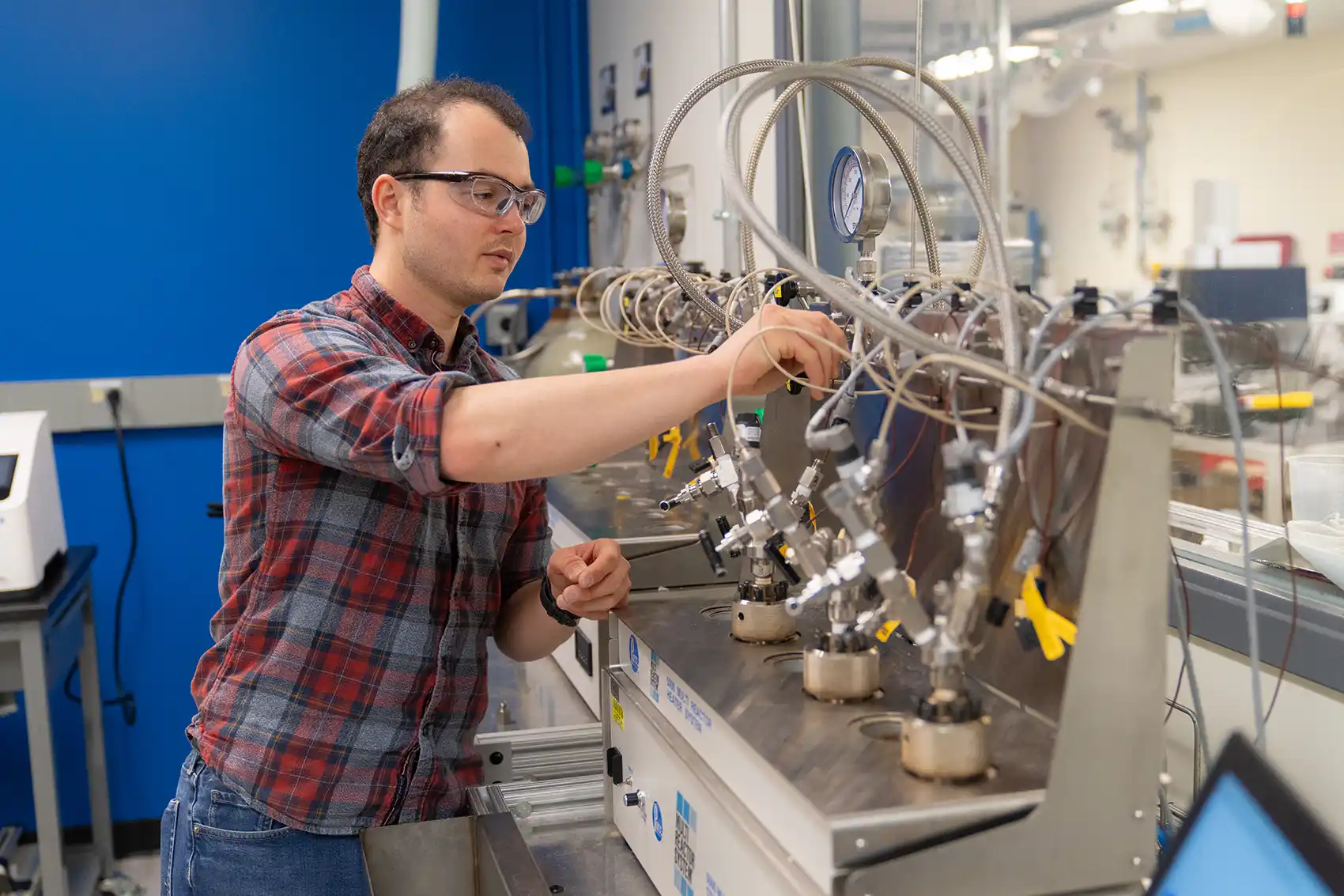 A scientist works with a reactor.