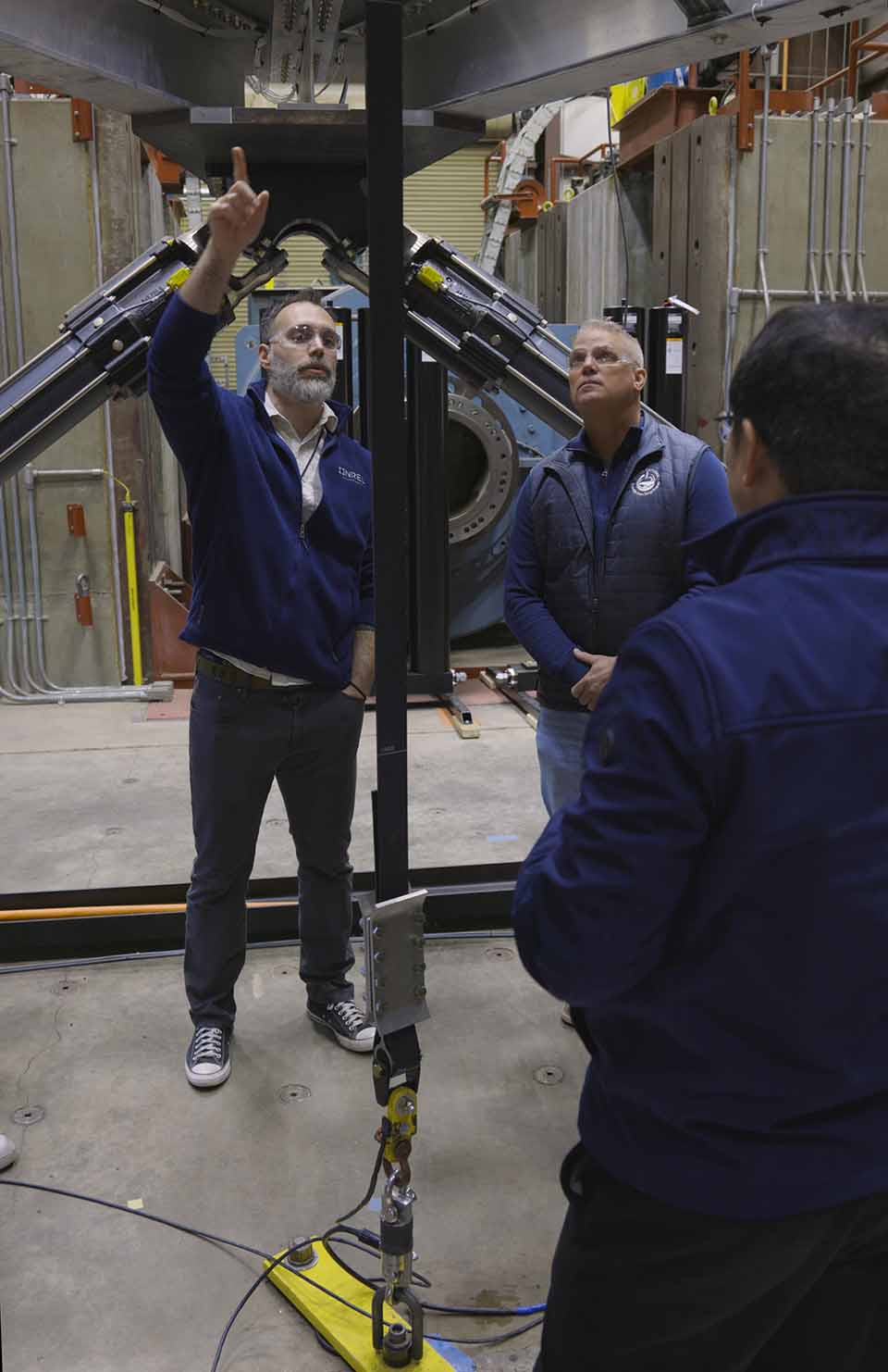 hero-wec-flt-97853 A photo of a group of people standing underneath large machinery.