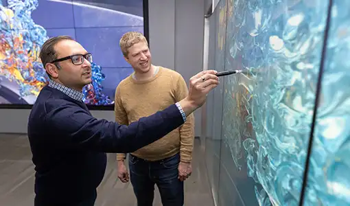 Continue reading about Two researchers look at a combustion simulation.