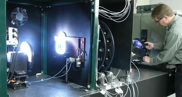 measurements-device-performance-14476 Spectral responsivity measurement system using 10nm bandwidth interference filters. L to R, lamp, mechanical chopper, shutter, filters, temperature controlled probe station with mirror.