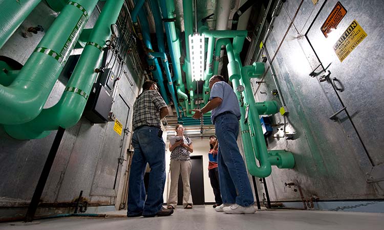 wip-21746 A team of engineers perform an energy audit of large HVAC systems.