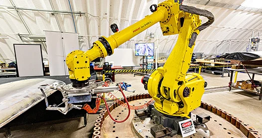 A yellow robotic machine in a laboratory.