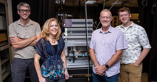 Four researchers smiling