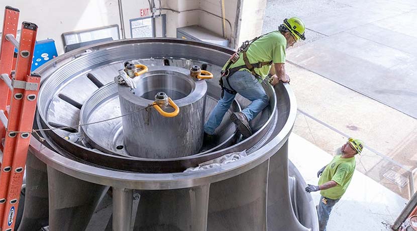 Two researchers work on a Dynamometer for water research at Flatirons Campus.