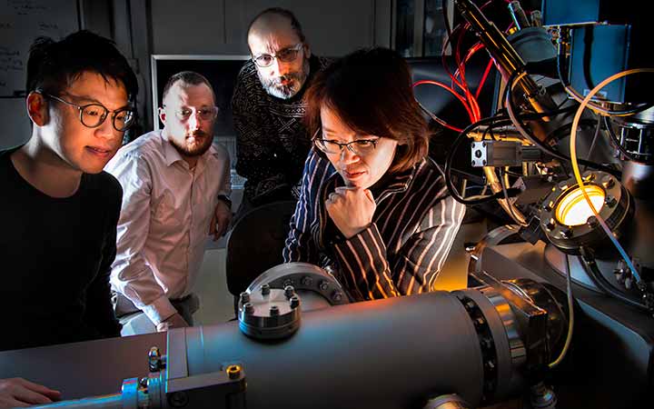 research-areas-49719 Four researchers working with a time-of-flight secondary ion mass spectrometry.