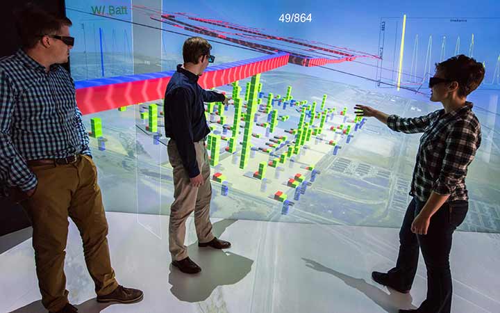 research-areas-50648 Three engineers use a 3D energy model to discuss potential energy loads of the proposed development growth.