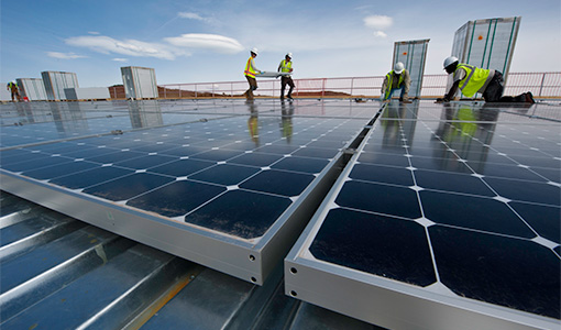 21576 Workers installing solar rooftop panels.