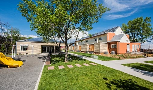 45207 Two school buildings featuring rooftop solar installations.