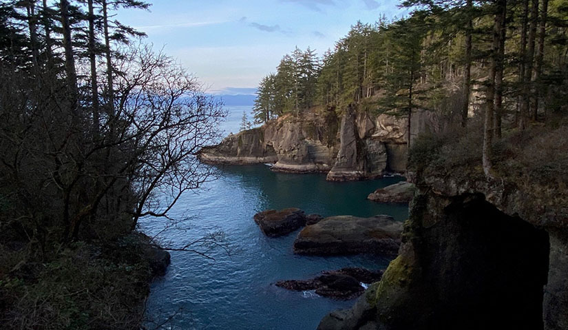 makah-1 Trees and rocks frame an inlet connected to the ocean.