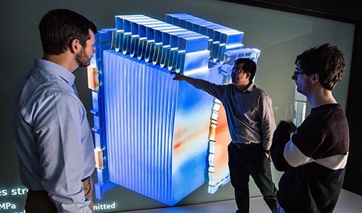 es-transportation Three researchers review a graphic rendering of a 3-D battery.