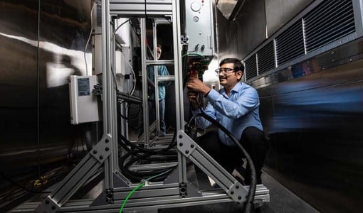stationary Researcher working on the residential battery test bed in the Energy Systems Integration Facility.