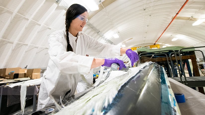 facilities-comet-61451 Person working inside the Composites Manufacturing Education and Technology Facility