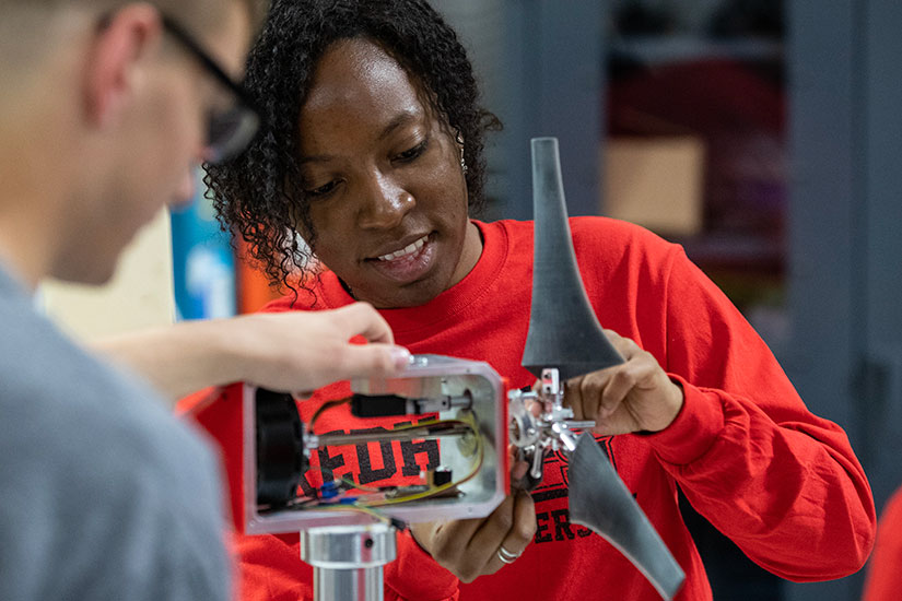 202204-newsletter-workforce Two people work on a wind turbine model