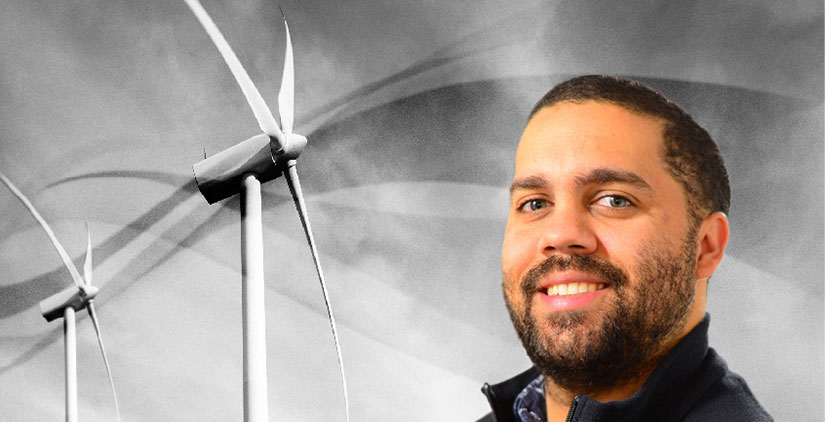20240723-newsletter-btb-cory-frontin A headshot of Cory Frontin in front of two wind turbines