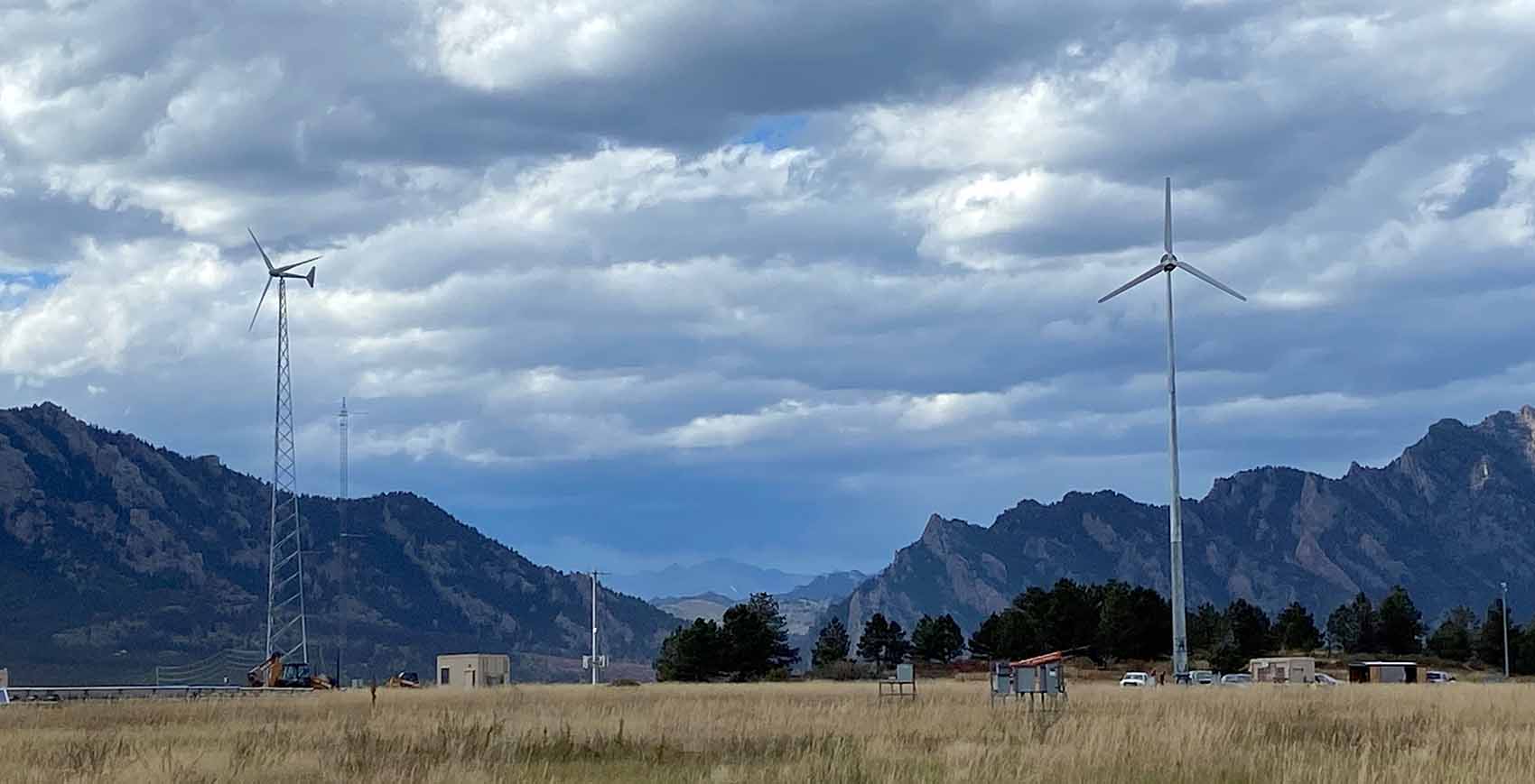 dswind-hero-flatirons-campus Three small wind turbines against a mountain backdrop.