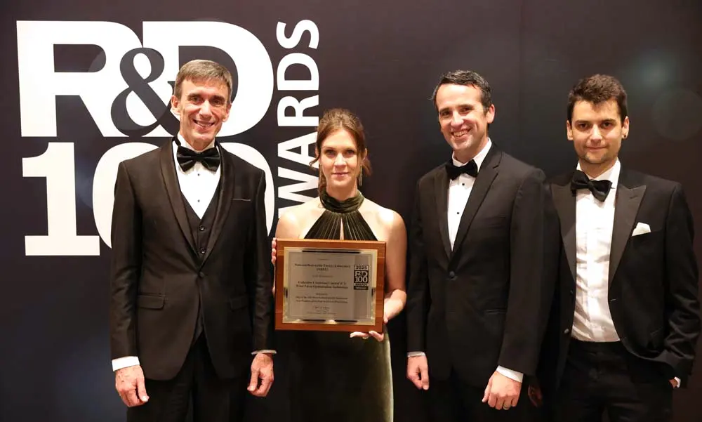 Four people in front of an R&D100 Awards backdrop.