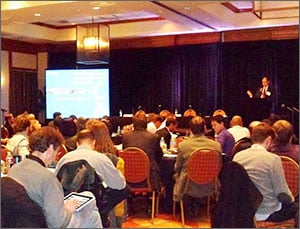 se_workshop_2013 Photo of a seated audience with a presenter at a podium and a projection screen in the background.