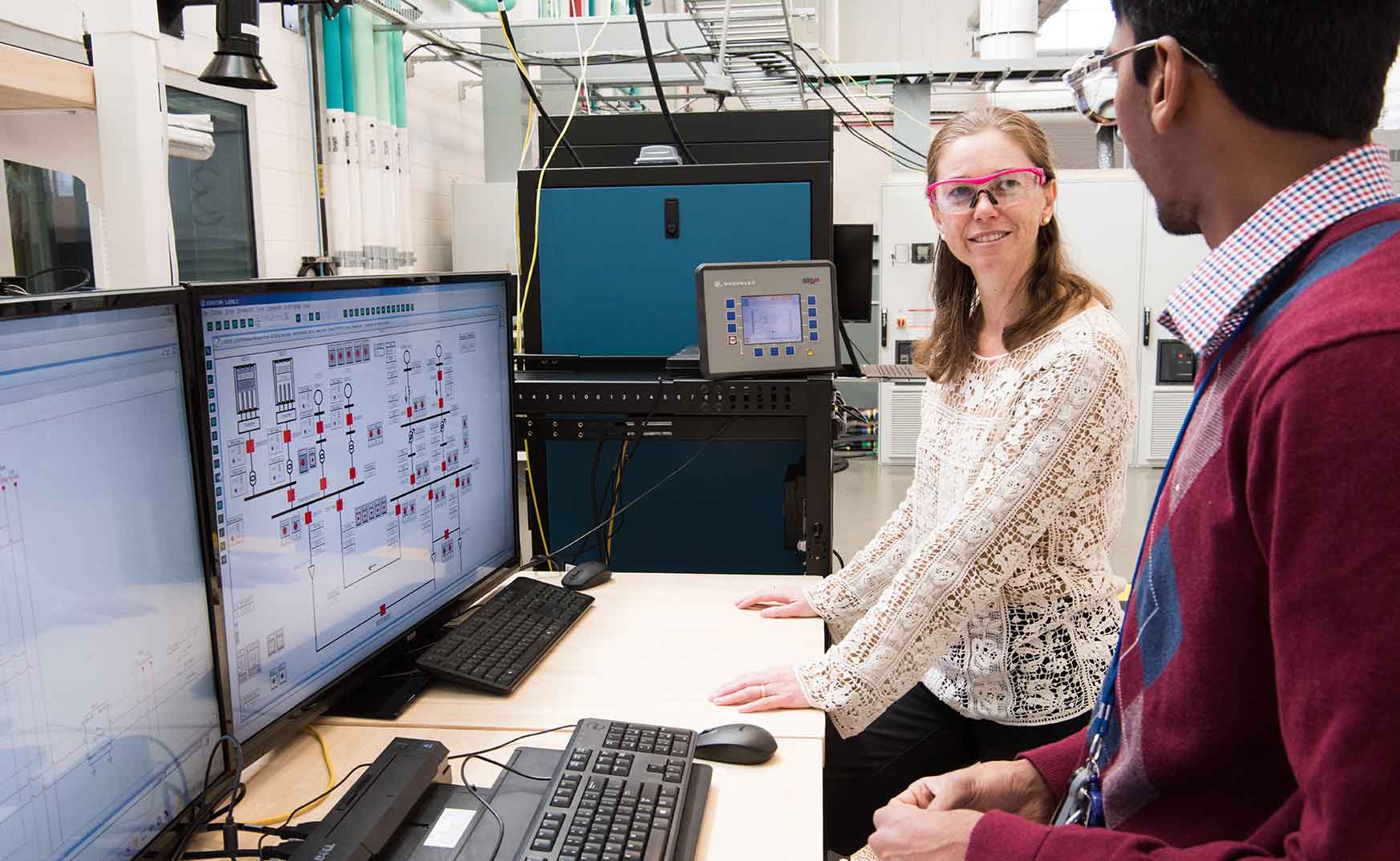 borrego-springs-41565 NREL engineers Kumar Prabhakar and Annabelle Pratt, run a grid simulation, using industrial scale inverters for a Borrego Springs Project.