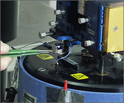 Scanning capacitance microscopy is performed in an atomic force microscope with an ultra-high frequency resonant capacitance sensor connected to a grounded tip via a transmission line, which is attached to an UHF capacitance sensor.