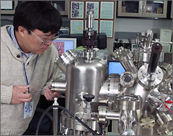 Photo of NREL researcher using scanning probe microscope.