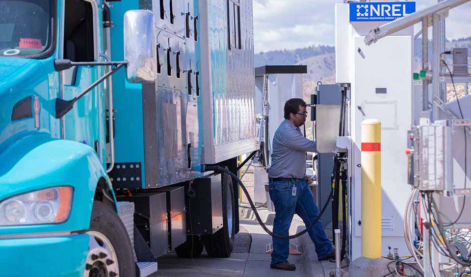 A person fueling a hydrogen vehicle.