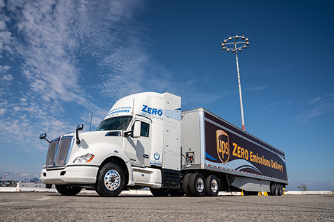 90387-flt Zero-emission truck hauling a trailer.