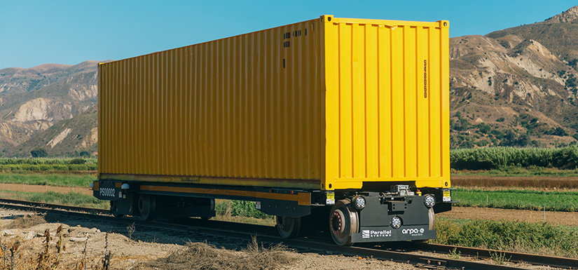 commercial-body-86273 Photo of a yellow battery-electric, self-propelling rail car against a mountain background.