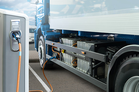 zev-trucks A heavy-duty truck at an EV charging station