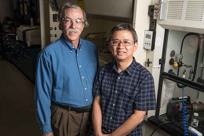 Photo of two men in a lab.