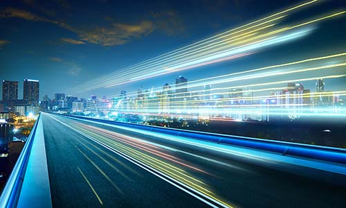 A city skyline and light trails at night