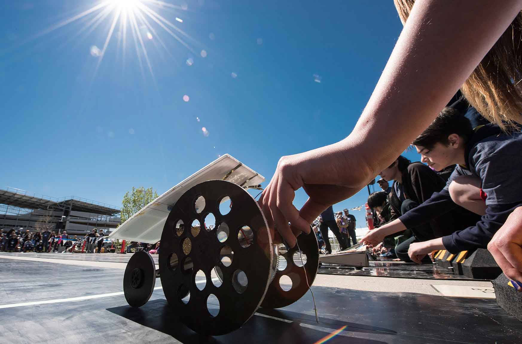 A model car draws power from the sun as the race begins.