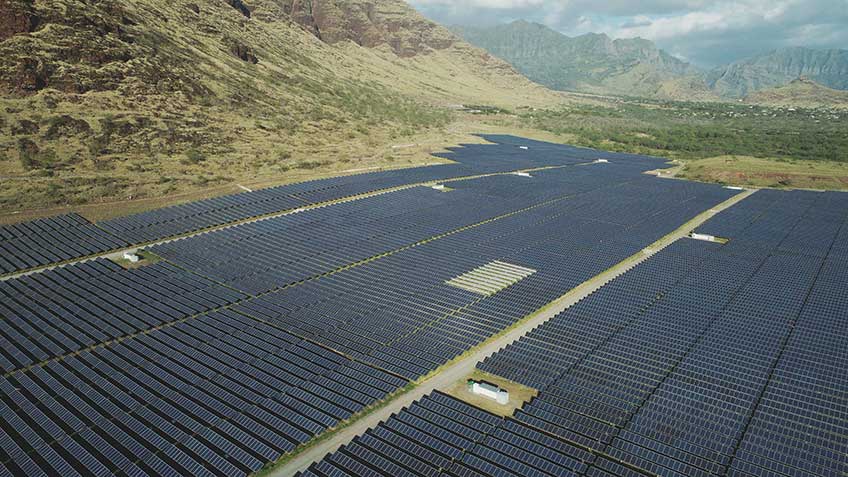 Aerial photo of a utility-scale solar power plant in a tropical environment.