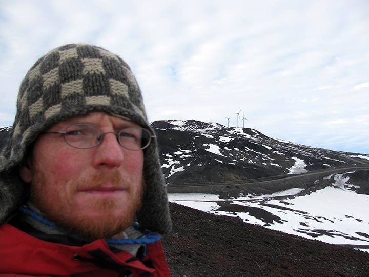 Baring-Gould in front of a mountain that has wind turbines on it.