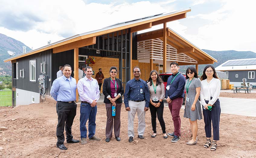 Development team in front of home.