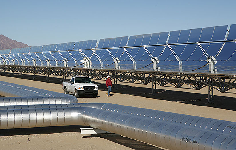 Photo of concentrated solar power parabolic trough receivers in a desert environment