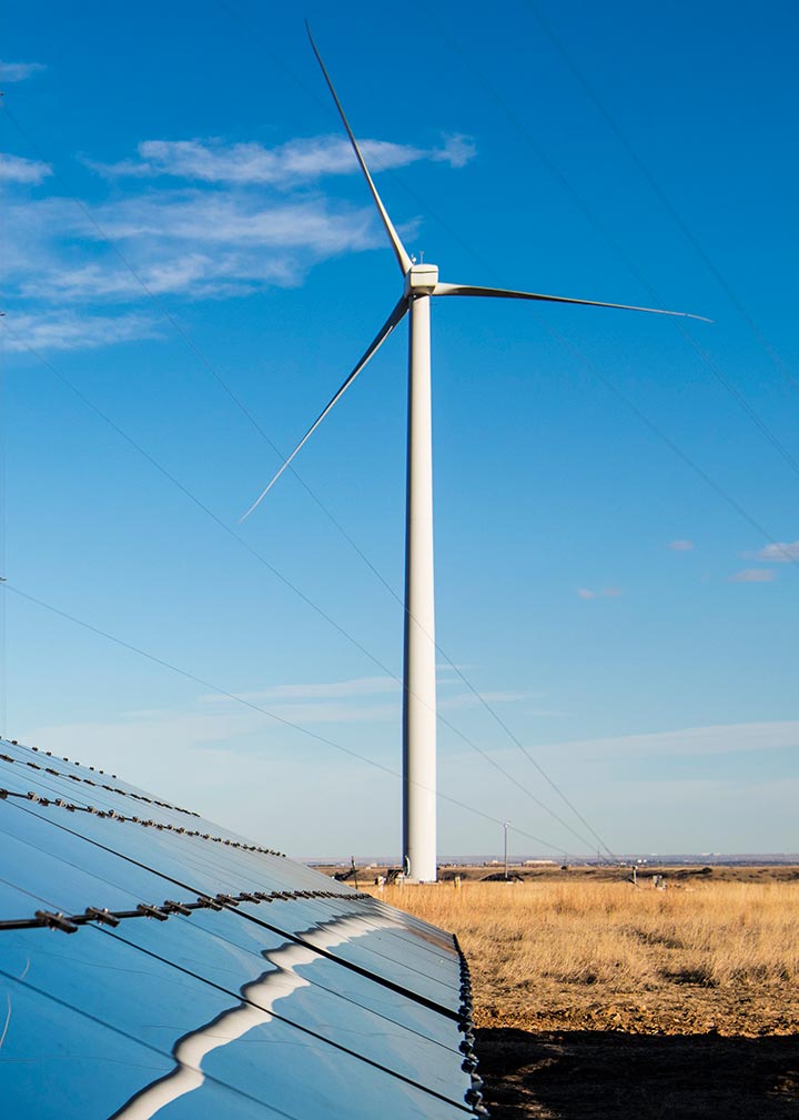 Photo of solar panels and a wind turbine at NREL’s Flatirons Campus.