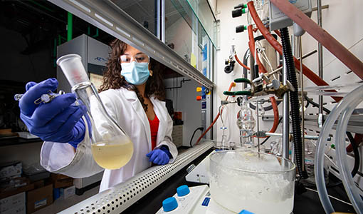 A researcher working with scientific equipment in a lab