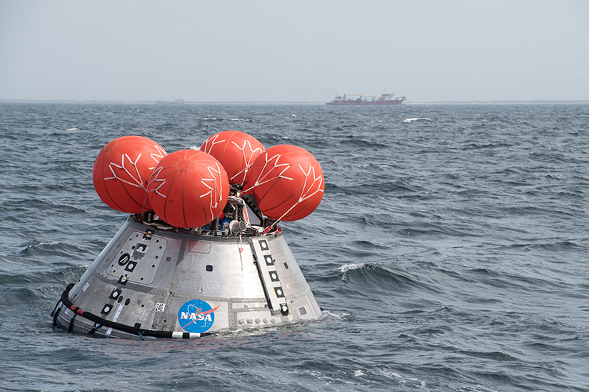 A space crew module floating in the ocean